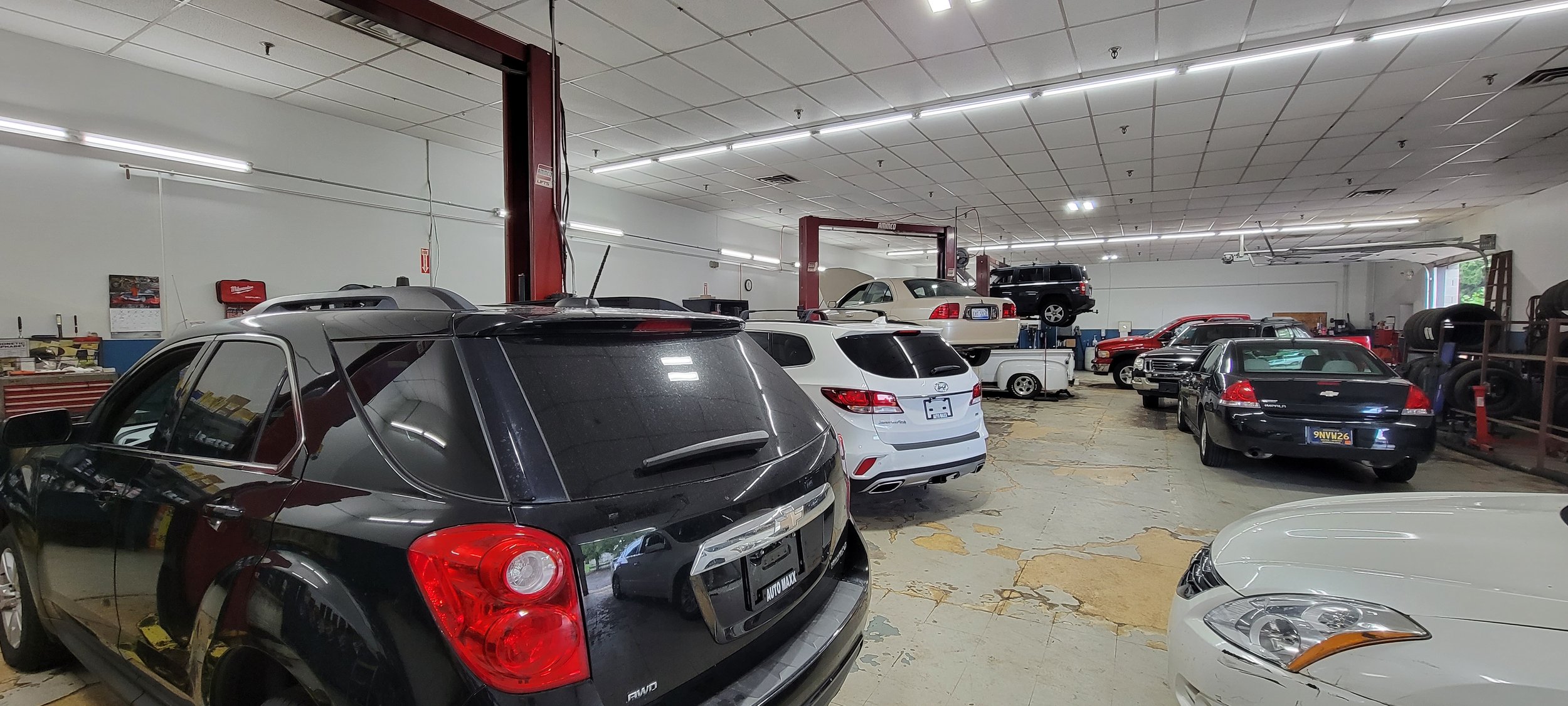 Miller Brothers auto repair garage bay with vehicles on lifts